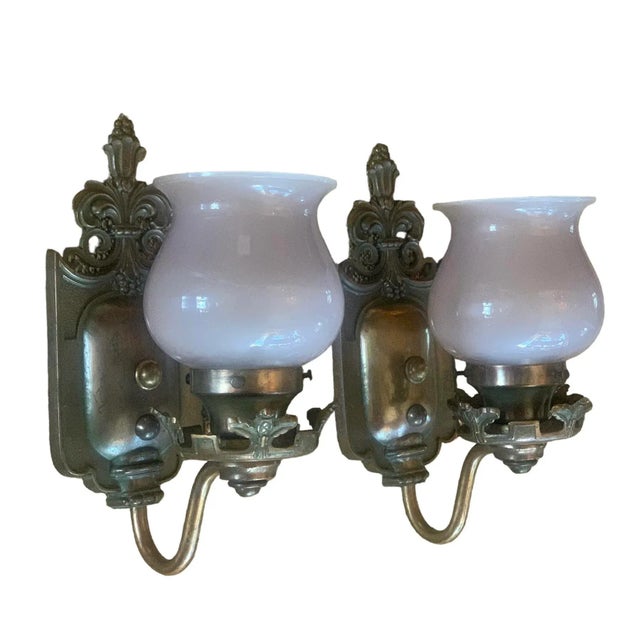 These are great sconces with definite leaf and berry pattern. The shades are frosted with a very slight lavender hue....