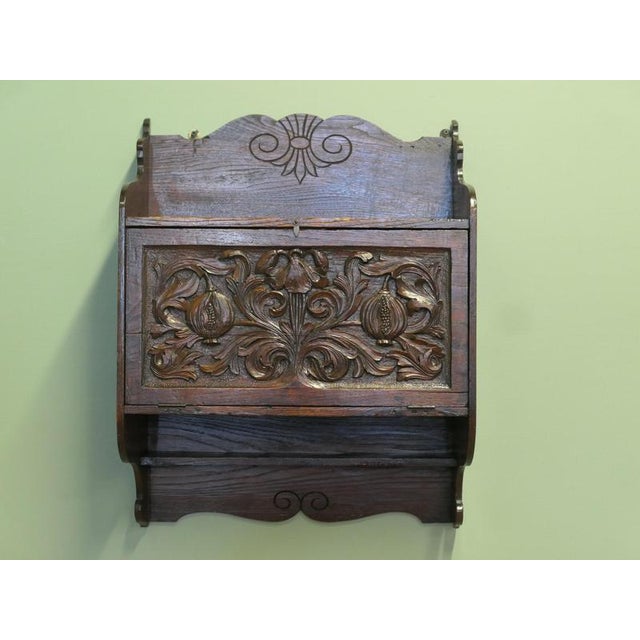 A very attractive piece, the cupboard can be wall hung showing the fruit and floral carving on the front of the door to...