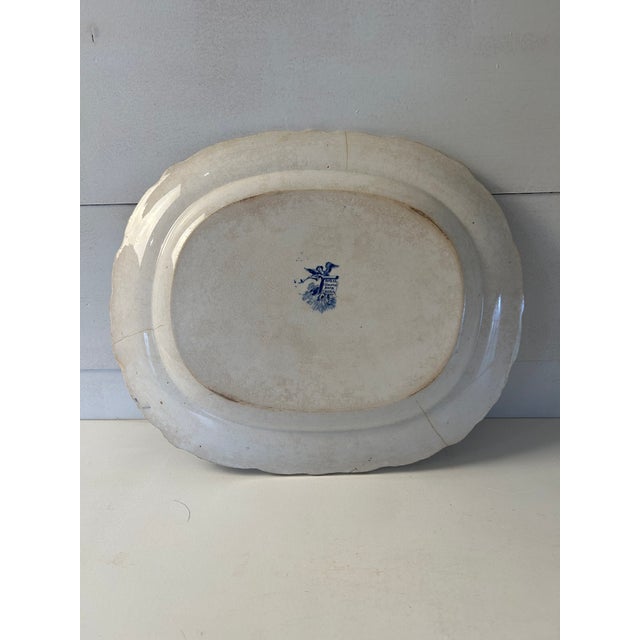 Charming c.1850 English Staffordshire platter depicting a scribe sitting beside a lake. Floral and foliate decoration...