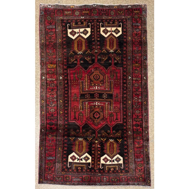 Antique hand-knotted rug from the Koliai Kurdish weaving region of western Iran, featuring a bold geometric composition...