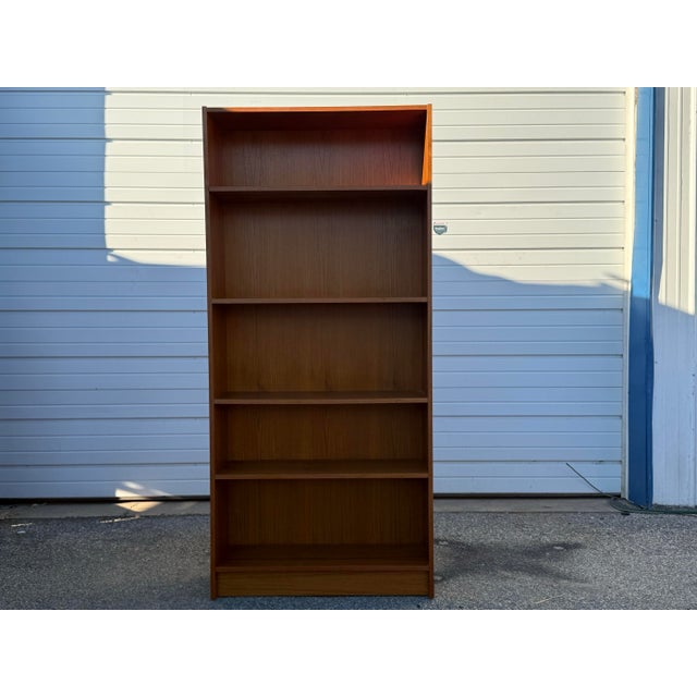 Mid-Century Modern Danish Modern Poul Hundevad Style Teak Bookcase Offered is a piece of time and design: a teak bookcase....