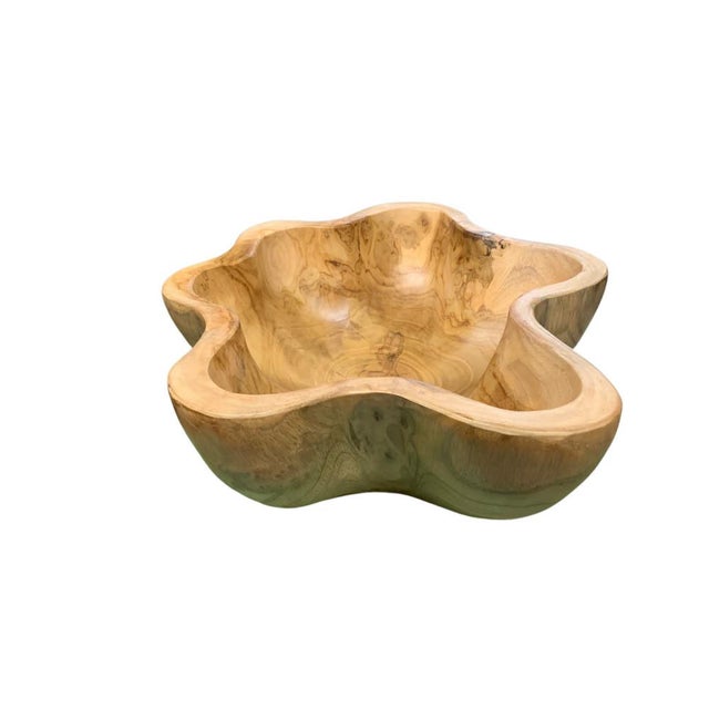 This teak live edge bowl is a unique piece showcasing the natural beauty of teak wood. Crafted by skilled artisans, its...