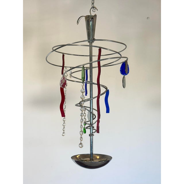 2 chandeliers by Toni Cordero for Magistretti from the 1980s, chromed steel structure and glass, the chrome plating will...