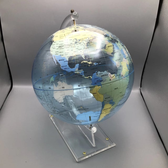 Featuring a screen printed light blue acrylic globe on a canted semi-circular clear acrylic rod form holder and wedge...