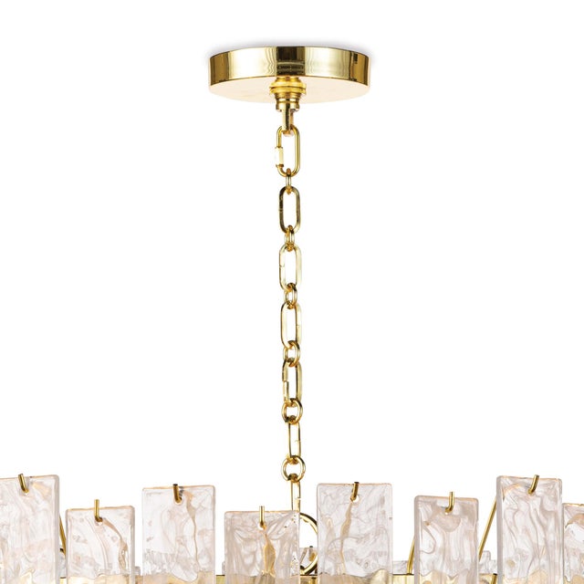 Panes of striking water glass adorn the large Glacier chandelier to create a dynamic piece full of movement. The glass...