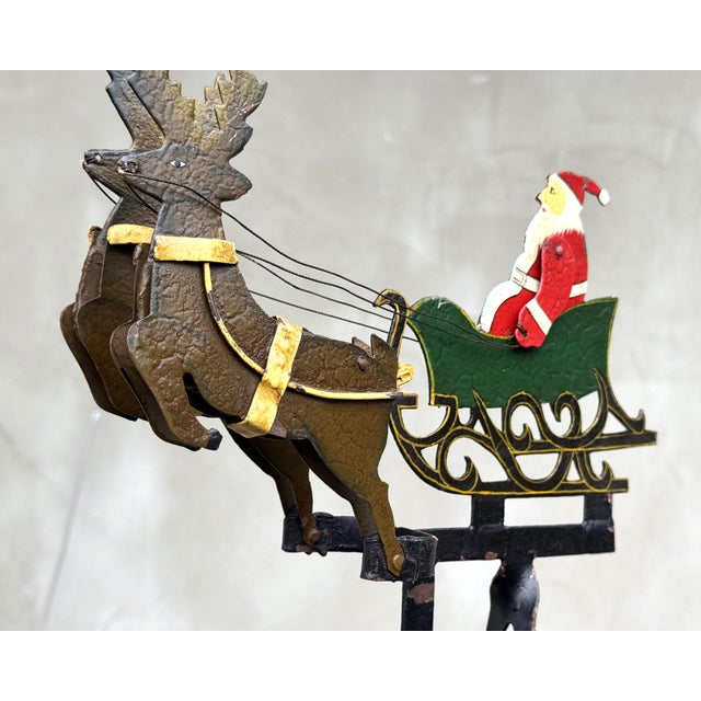 This rare vintage kinetic balance sculpture depicts Santa Claus seated in a sleigh pulled by reindeer, designed as a...