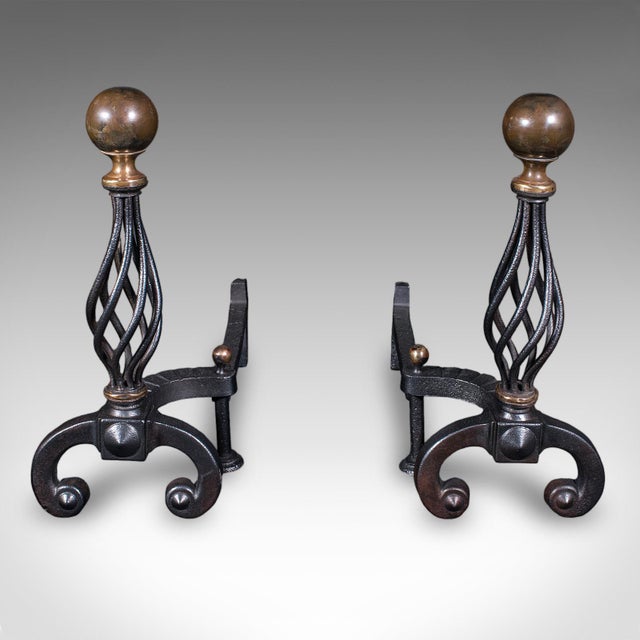 This is large pair of antique fire dogs. An English, cast iron and brass andiron in Aesthetic Period taste, dating to the...