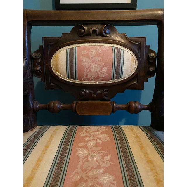 A mid-19th-century French reception chair in carved wood, in the Neo-Renaissance style. The armrests are supported by...