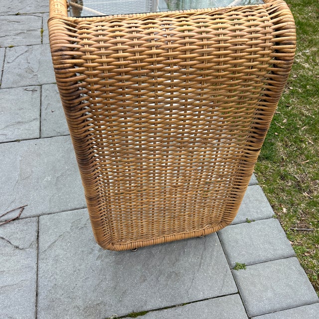 Two tier glass and wicker waterfall console table.