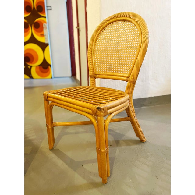 A very nice pair of vintage round back rattan chairs. Maker unknown but originating in Sweden in the 1970's.