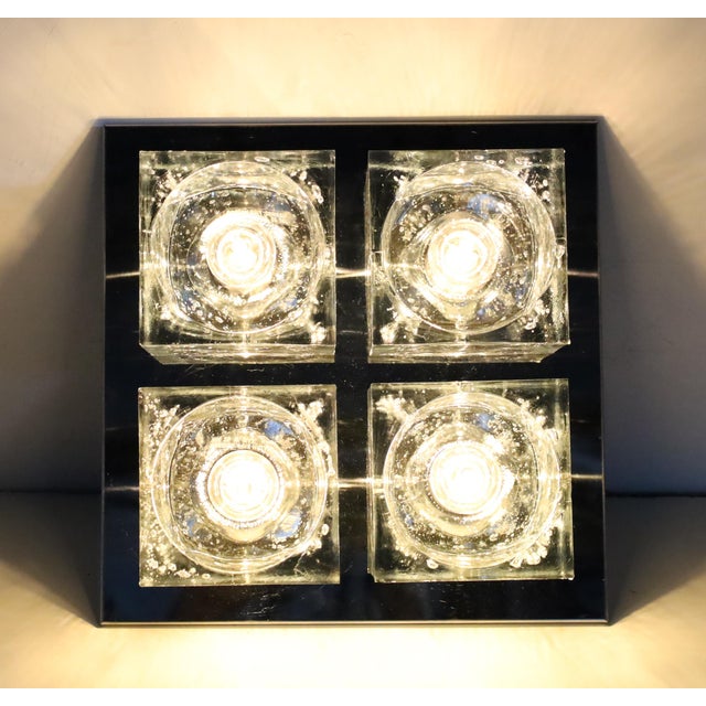 This can be hung as a sconce or as a ceiling light. One of his more famous designs, Murano glass block cubes that create...
