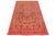 This vintage overdyed Persian wool rug features a captivating pinkish-orange field with charming brown floral accents....