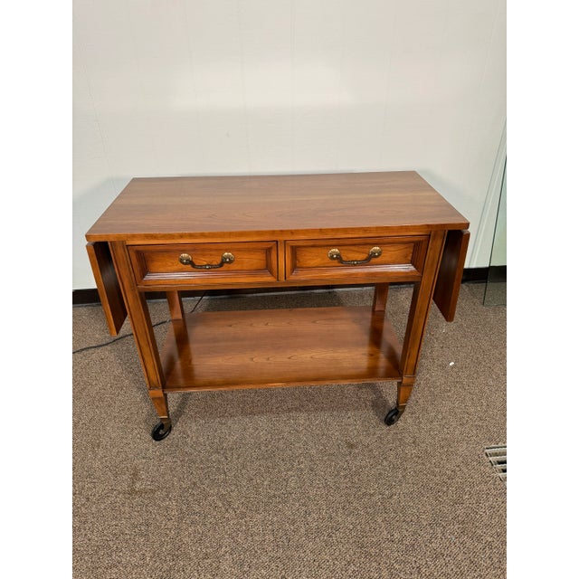 62 inch’s in width when fully extended. The top has some circular spots on the top. Wheels on foot work well and allow for...