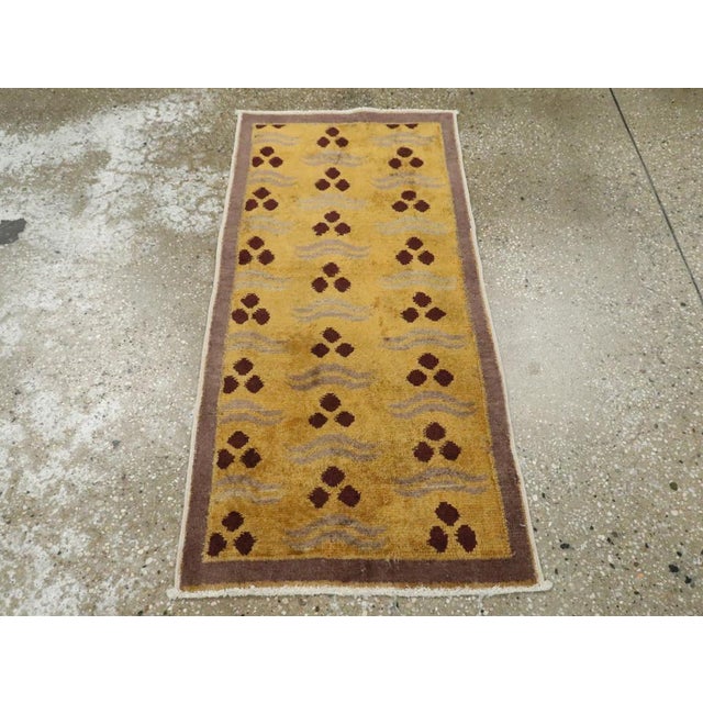This Mid-20th century Turkish Art Deco throw rug, measuring 1' 7" x 3' 3", captures the refined elegance and experimental...