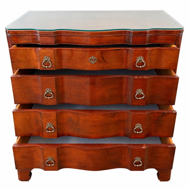 A handsome pair of vintage John Stuart mahogany chests featuring elegant serpentine fronts, four spacious drawers,...
