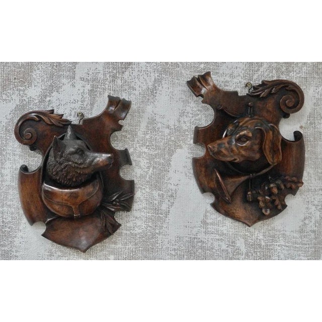 A Superb Pair of Black Forest Trophy Plaques. Beautifully detailed hand carvings, with a carved dogs head and game bag,...