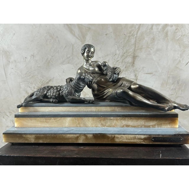 Beautiful regula statue on a stepped marble base depicting a woman surrounded by a sheep and its young. Dating from the...