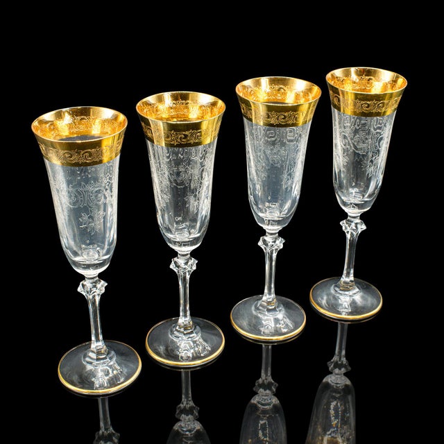 This is a striking set of 12 vintage champagne flutes. A Continental, gold leaf coated wine glass suite, dating to the...