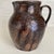 One of a kind traditional southern style pottery pitcher in a mottled brown drippy glaze finish. Nice lustre remains on...