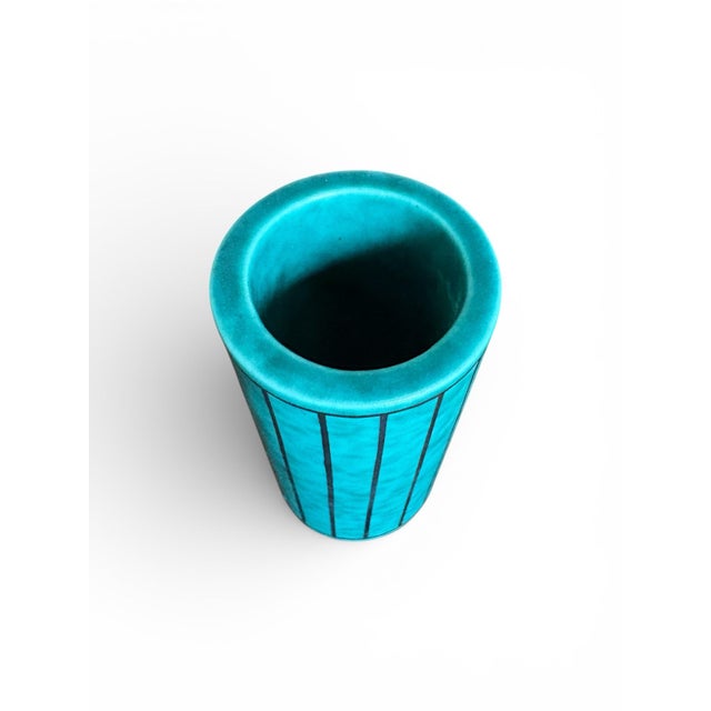 This stunning ceramic turquoise vase has applied designs of vertical stripes and was designed by Wilhelm Kåge for...