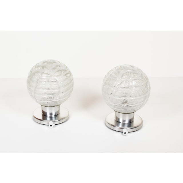 Stunning and high quality set of glass and polished metal "ice glass" wall lights by Doria, Germany 1970's. In great...