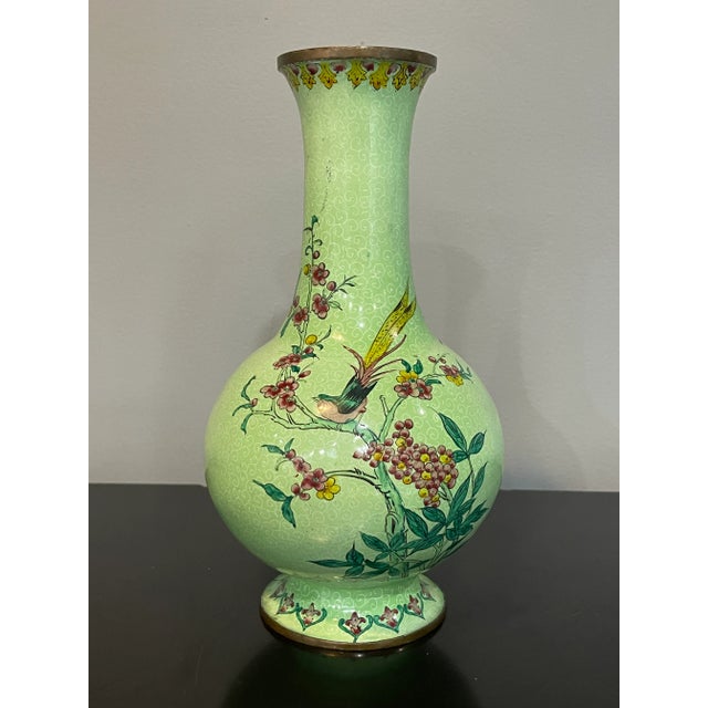 Early 20th century Chinese brass enamelled handmade bottle vase. The vase is decorated with a pair of birds resting on a...