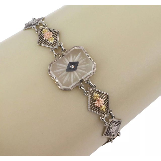This is a lovely Art Deco bracelet, it is crafted from 14k white gold with rose and yellow gold accent featuring a...