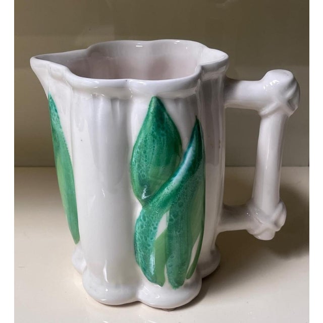 A carafe and glass set with textured reliefs designed by colin morrow, an international designer who was particularly...