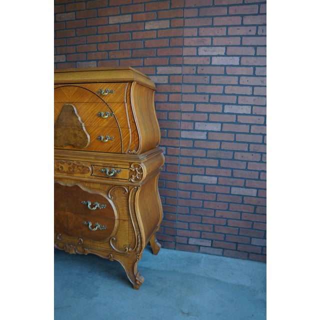 Amazing antique highboy chest. Finely crafted by Joerns Brothers Furniture, with incredible veneer work and adorned with...