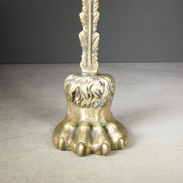 A 19th-century English brass doorstop shaped like a lion’s paw and ankle sitting on a hefty leaded base for weight and...
