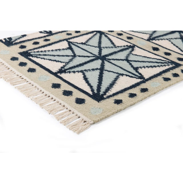 The serene beauty of the Star Rug was inspired by Moroccan tiles and antique American quilts. Symmetrical starbursts...