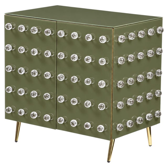 This olive-green Murano-glass cabinet combines an earthy colour with luminous clear glass and restrained brass details....