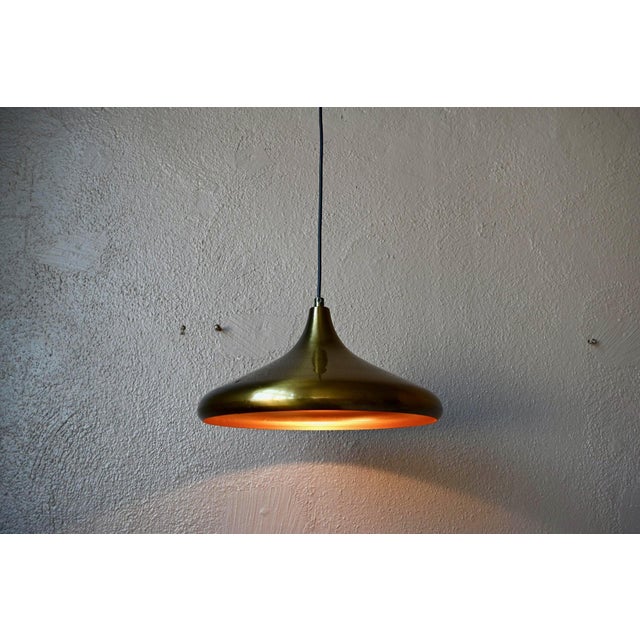 A beautiful vintage pendant light that evokes the spirit of the 60s and 70s and their creative optimism! Its flattened,...