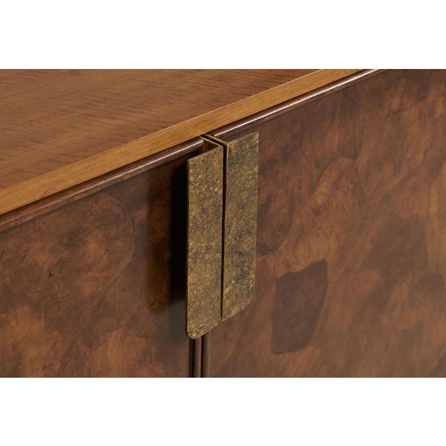 Large credenza featuring crazy cut walnut swirl cabinet fronts set atop a medium forged iron base. Hammered bronze door...