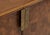 Large credenza featuring crazy cut walnut swirl cabinet fronts set atop a medium forged iron base. Hammered bronze door...