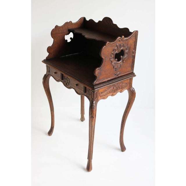 This charming antique French nightstand, crafted in solid oak around 1900, is a true Louis XV beauty and a real jewel for...