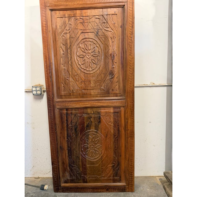Make a grand first impression with this exquisite pair of antique double entry doors, meticulously hand-carved from solid...
