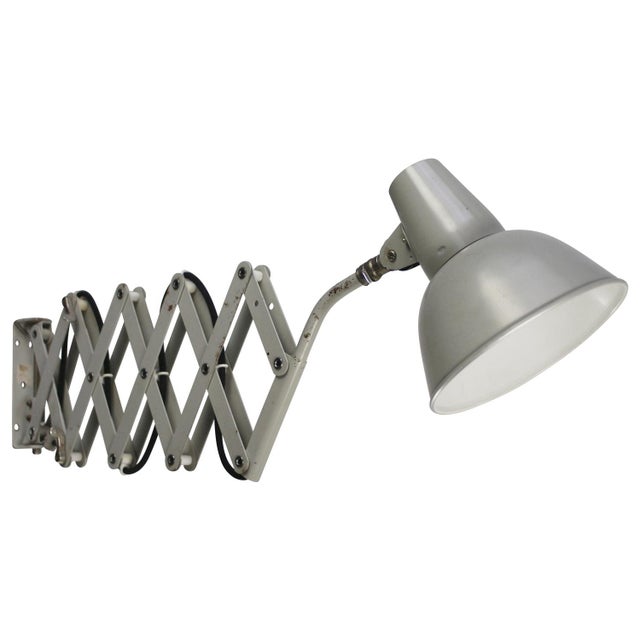 Sis scissor wall lamp grey metal shade and silver interior adjustable length and horizontally and vertically swiveling arm...