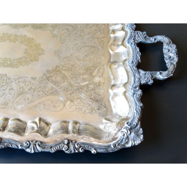 Mid Century rectangular footed plate silver serving or drinks tray with handles. It has an ornate scalloped decorative...