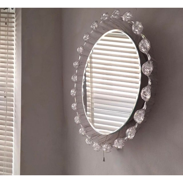 Large mid century melted ice effect illuminated circular wall mirror / wall light dating from about 1970. Beveled mirror.
