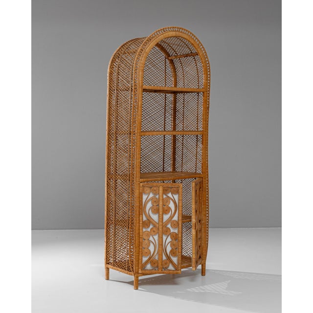 This charming 20th-century French wicker cabinet brings a touch of vintage whimsy with its intricately woven rattan design...