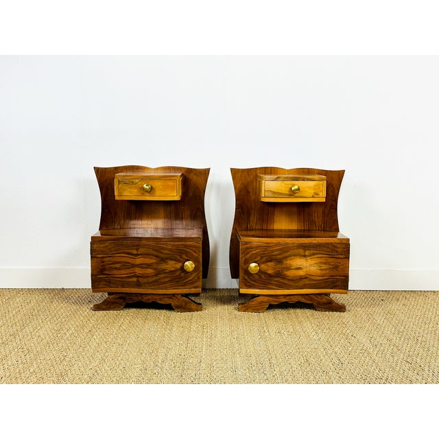 An elegant pair of Art Deco bedside tables dating from the 1940s, crafted from walnut veneer with superb grain and a...