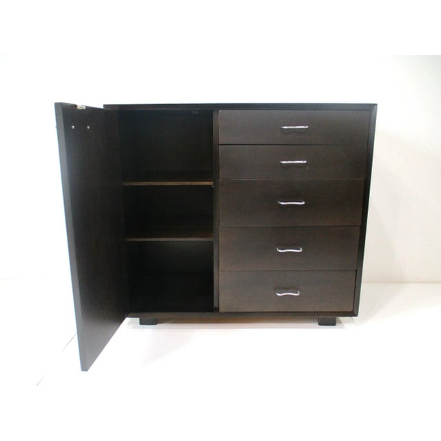 A early George Nelson designed Mid Century dresser chest with a door to one side having two adjustable shelves . The other...