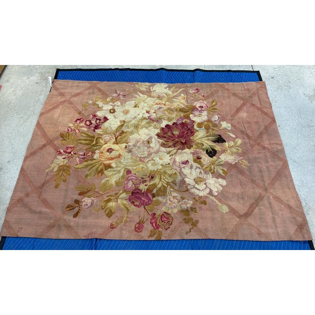 Large antique handwoven floral French Aubusson tapestry. The tapestry is composed of A vibrant floral motif medallion in...