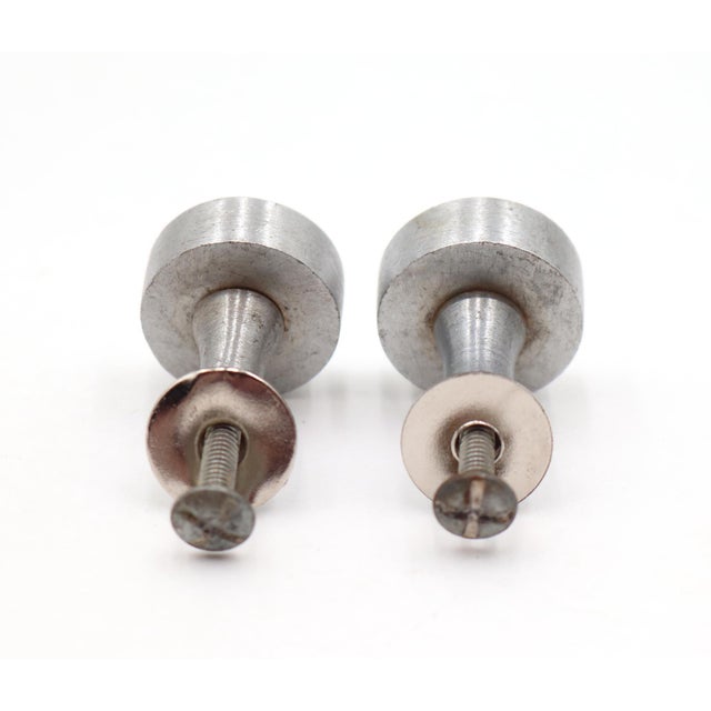 Modern style flat front cylinder shaped cabinet or drawer knobs made of brass with a brushed nickel finish. Mounting...