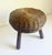 A vintage tripod wicker stool, attributed to Tony Paul, Circa 1950s. Stout, tapered, angled maple legs give support to the...