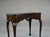 George II Irish mahogany card table with carved scalloped shell on frieze, raised on shell carved cabriole legs on pad...