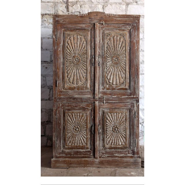 This antique carved cabinet is a striking blend of old-world craftsmanship and rustic elegance. Hand-carved from solid...