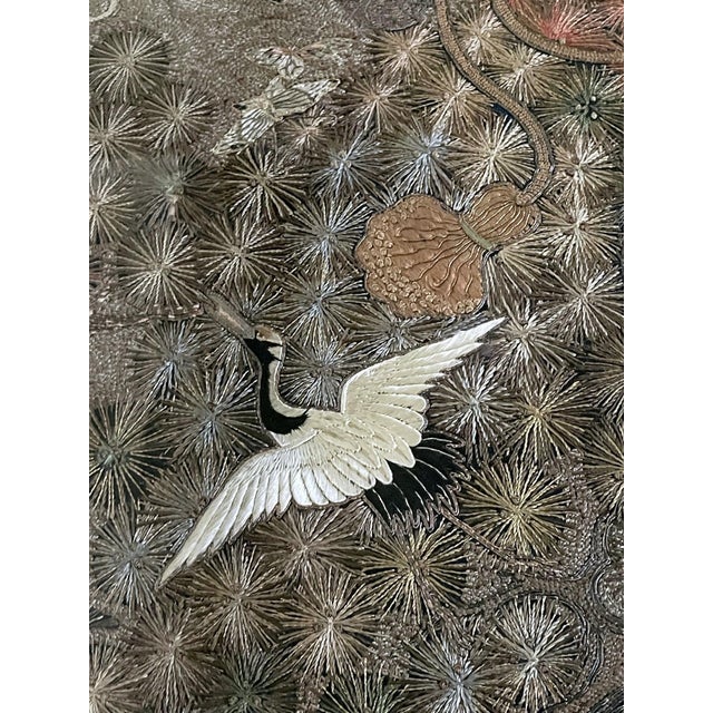 A spectacular Japanese embroidered silk panel beautifully presented in a gilt frame suspended in a lucite shadow box with...