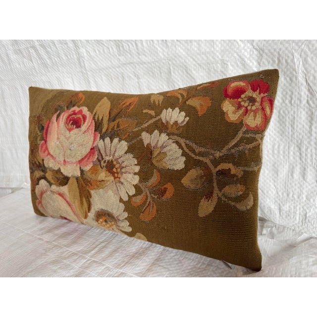 This elegant 19th century French Aubusson pillow features a richly detailed floral composition woven in soft, time worn...